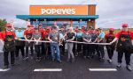 How does Popeyes decide where to build a store?